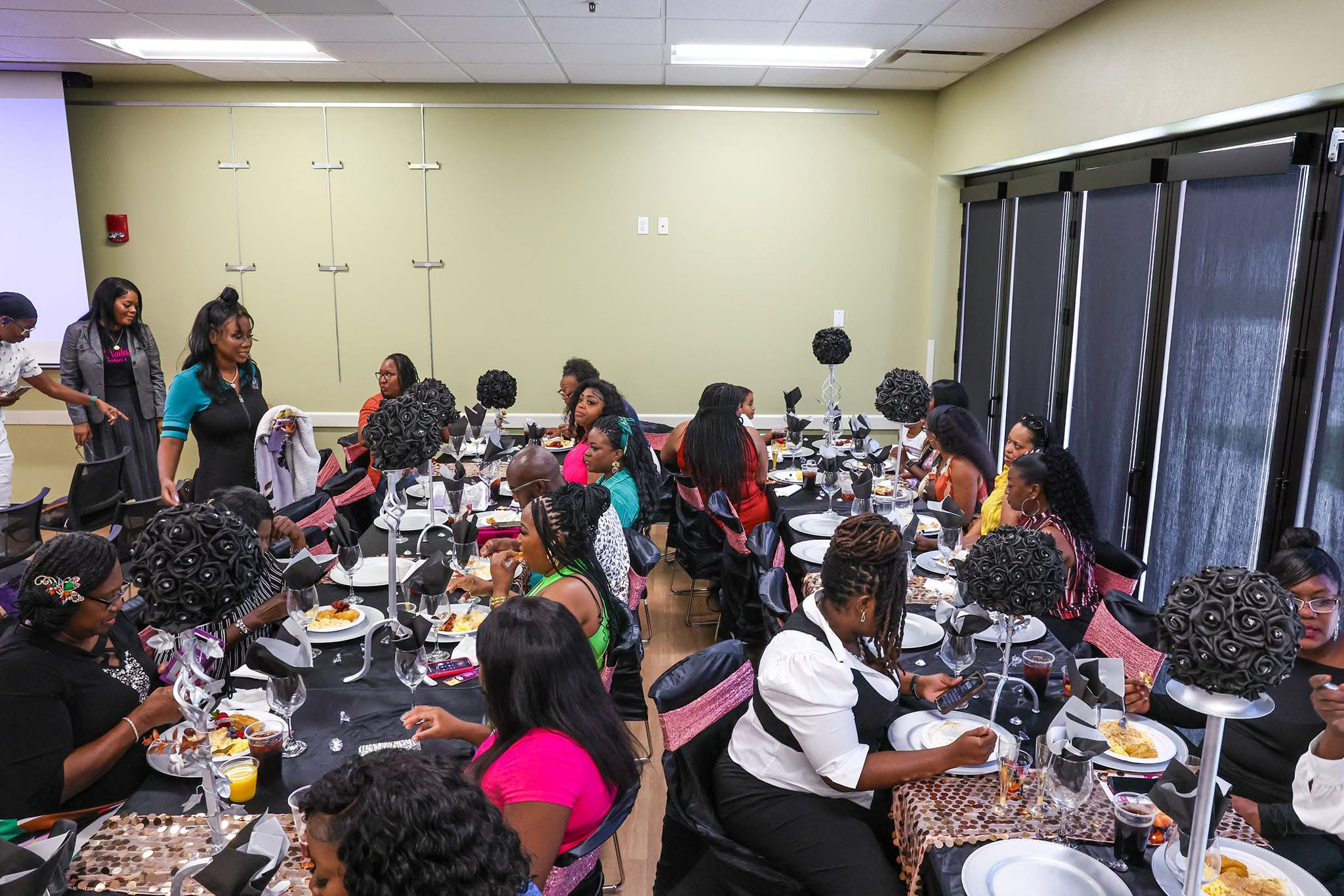 Women connecting and sharing a meal at a She Nailed It community gathering